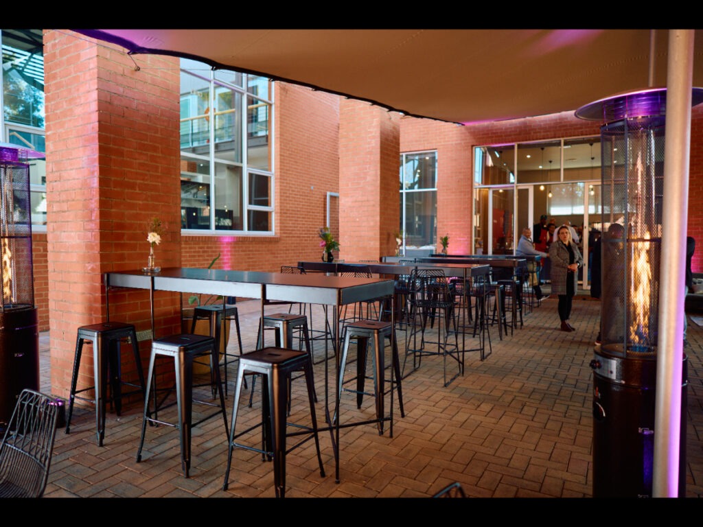 Event bar setup with cocktail furniture under stretch tent