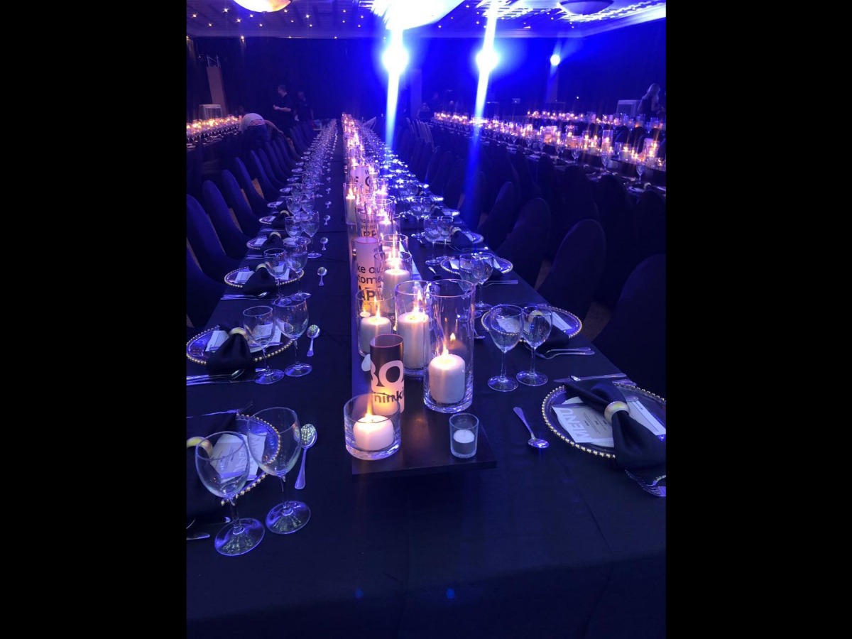 Long luxury dinner table setup with black and gold décor – styled by Animate-Co in Cape Town