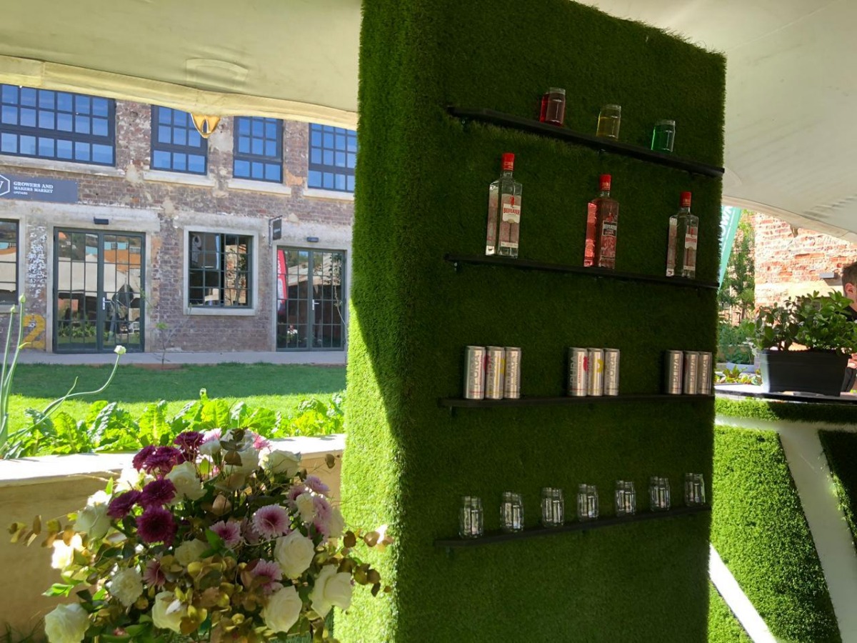 Green grass feature wall with drink display at Cape Town event