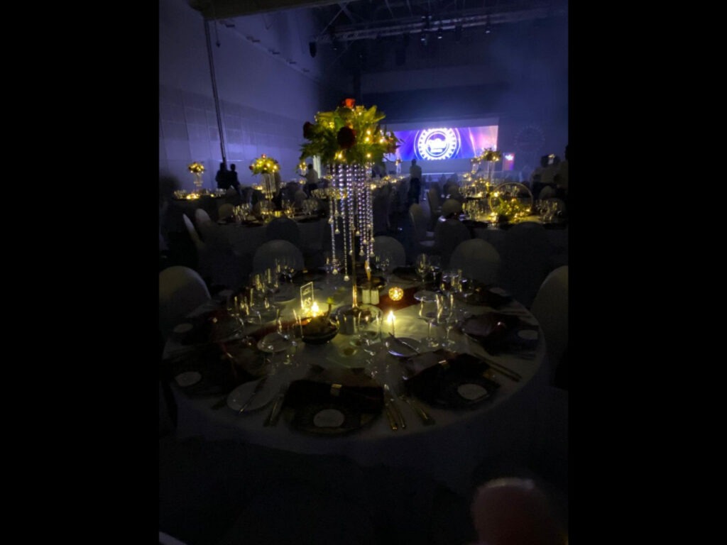 Luxurious candlelit gala dinner table setup with floral centrepieces
