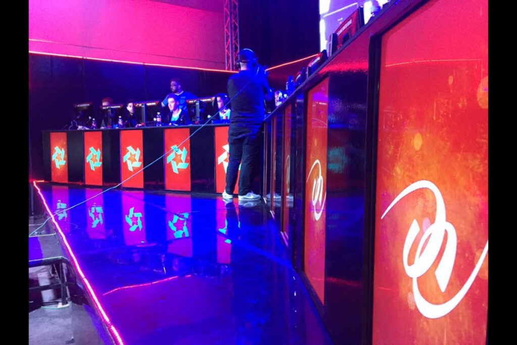 AV crew at LED DJ booth with red lighting