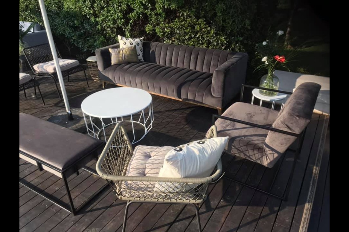 Outdoor velvet event seating in lush garden setting