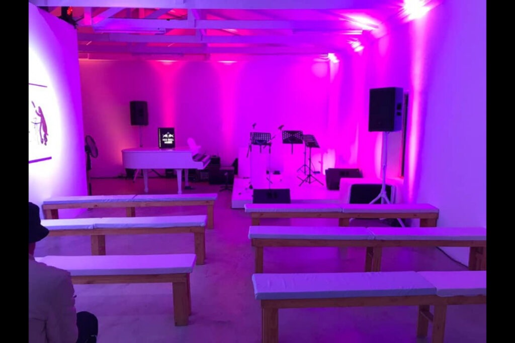 Minimalistic event setup with pink AV lighting – Cape Town