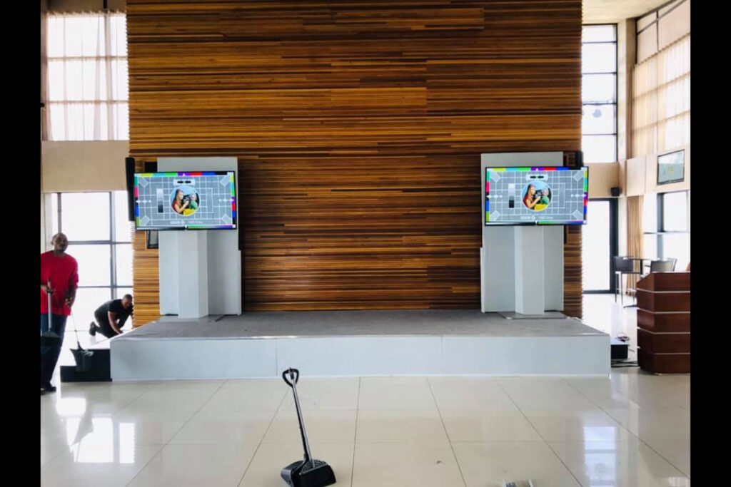 Podium stage with AV screens and wood backdrop – Event Tech