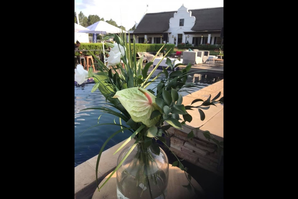 Vase with white flowers on wooden deck
