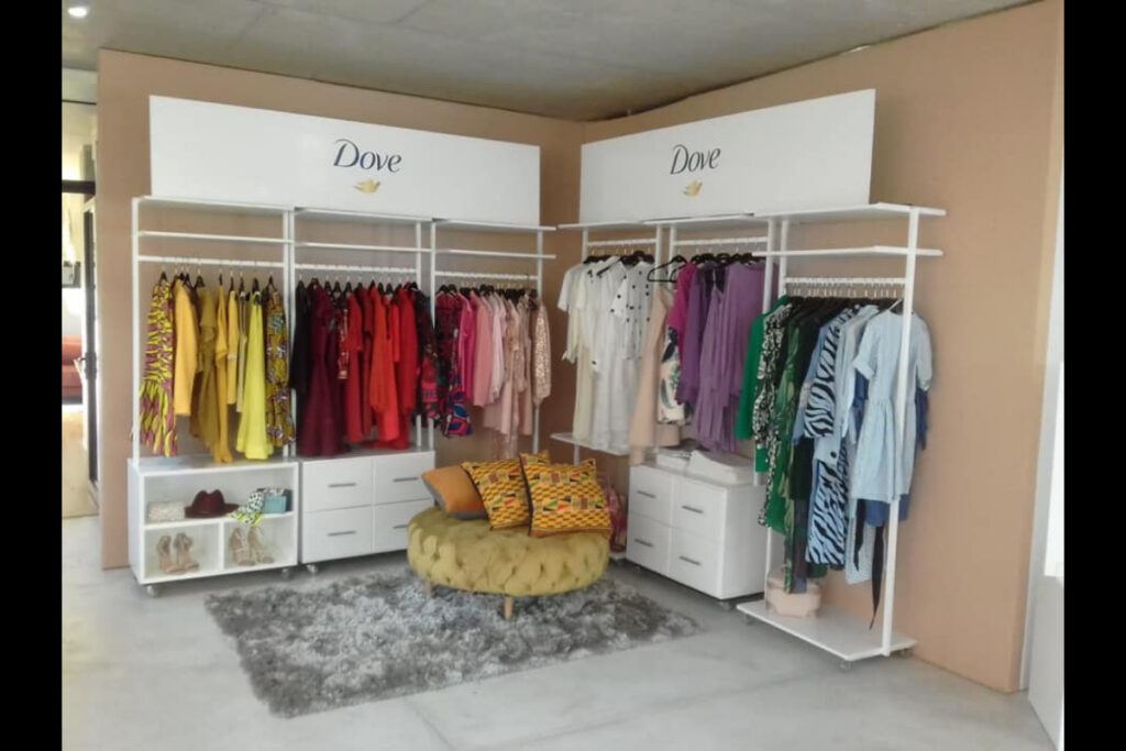 Boutique-style retail expo stand with custom clothing racks and decor