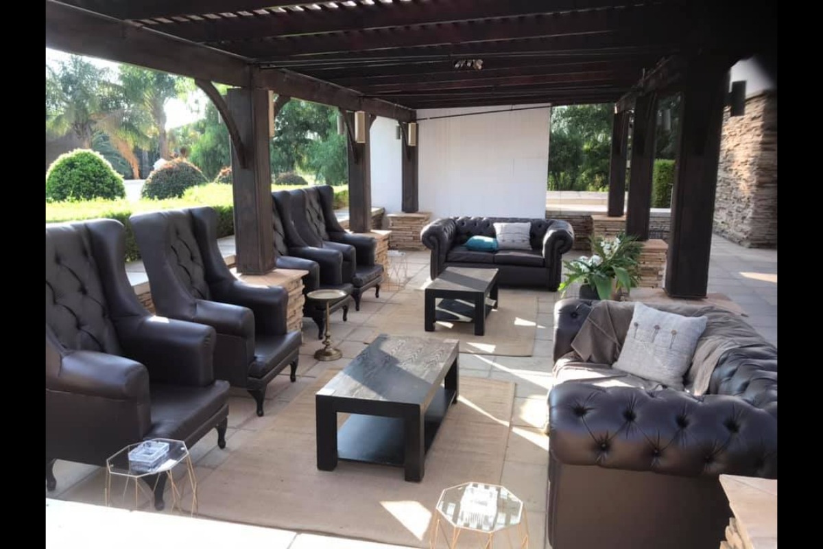 Outdoor event lounge with leather armchairs and coffee tables