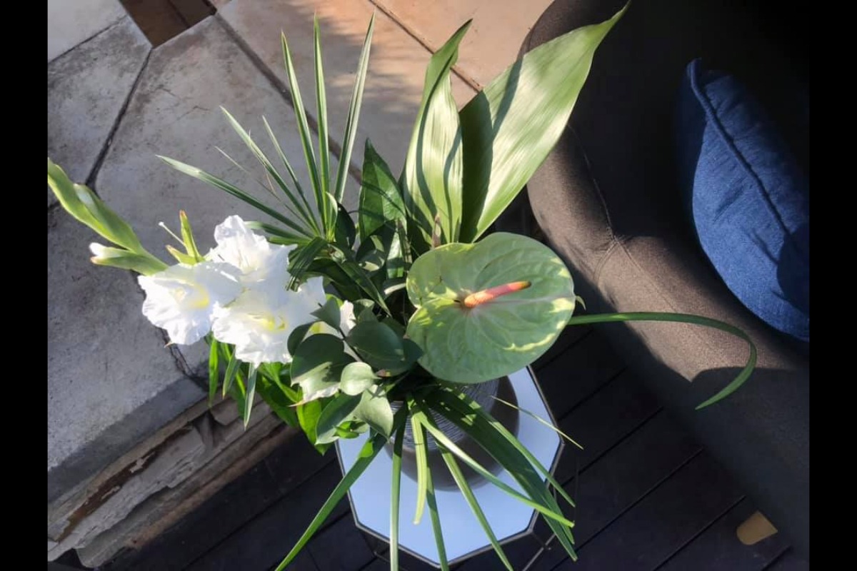 White flowers with greenery in lounge setup