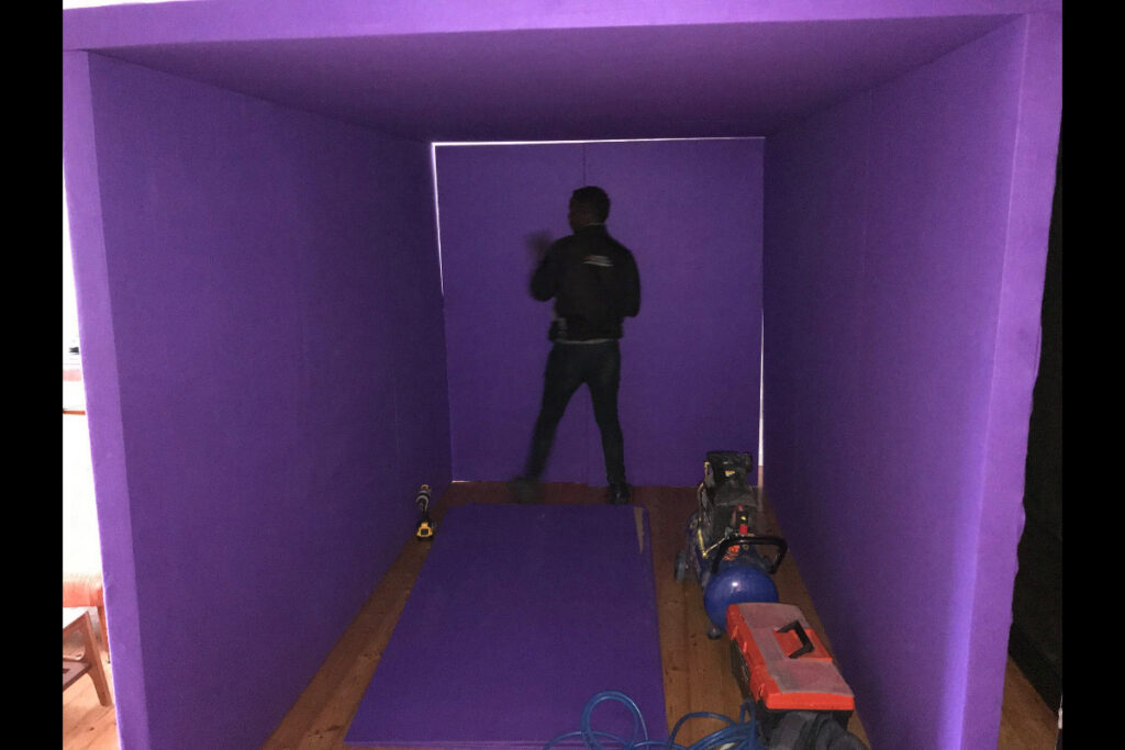 Interactive purple tunnel photo booth installation with silhouette figure