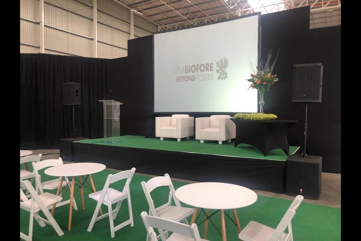 Indoor conference setup with white chairs and couches on green carpet – Cape Town event styling