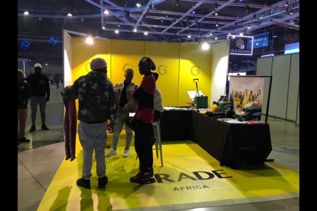 branded expo stand with yellow floor and black wall