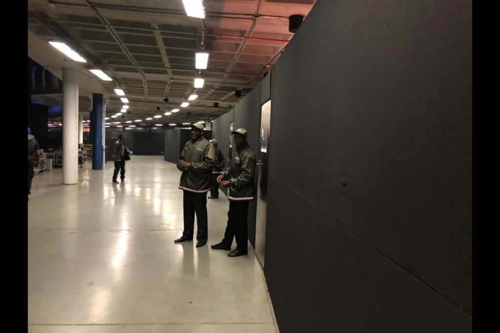 Expo entrance tunnel with black draping and event crew