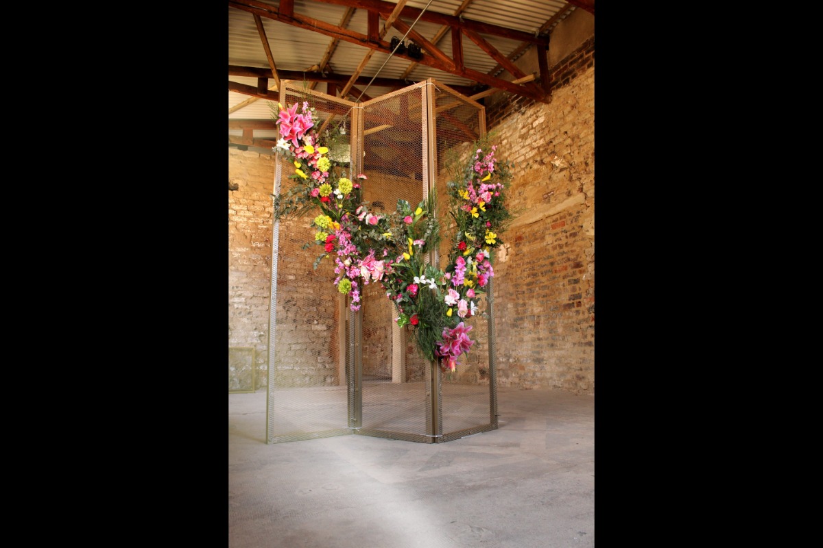 Custom mesh floral wall in rustic venue