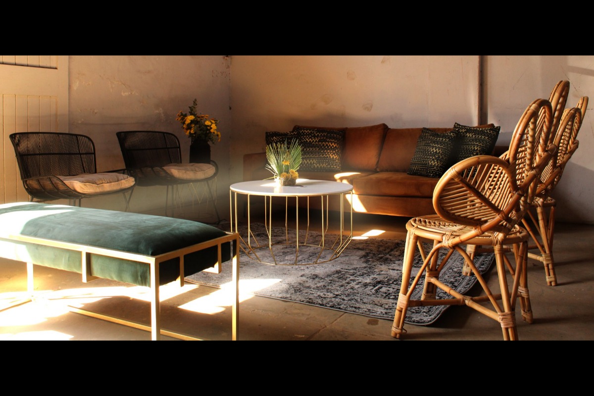 Lounge event furniture setup with rattan chairs and natural textures in Cape Town