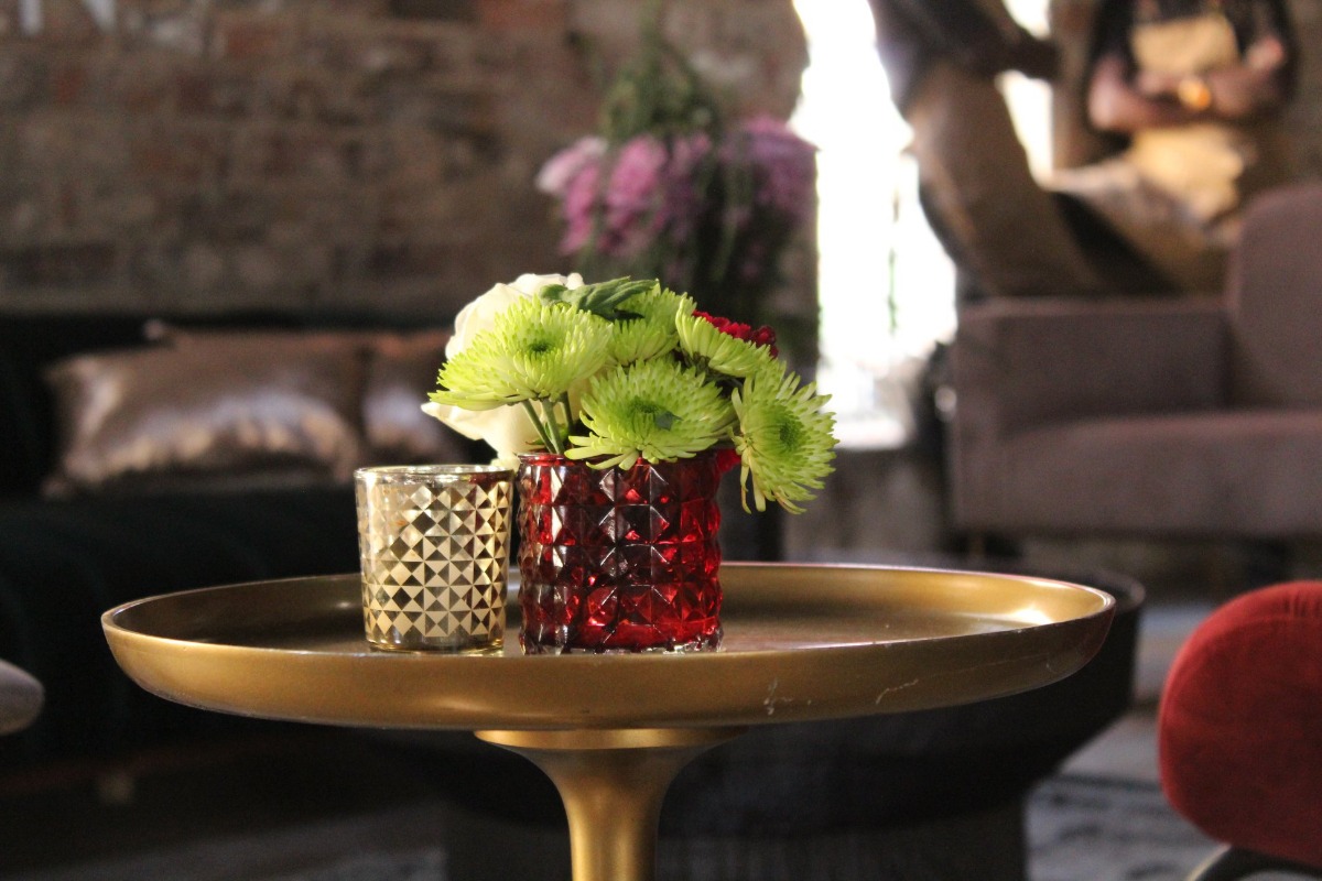 Bright green floral centrepiece in a red vase