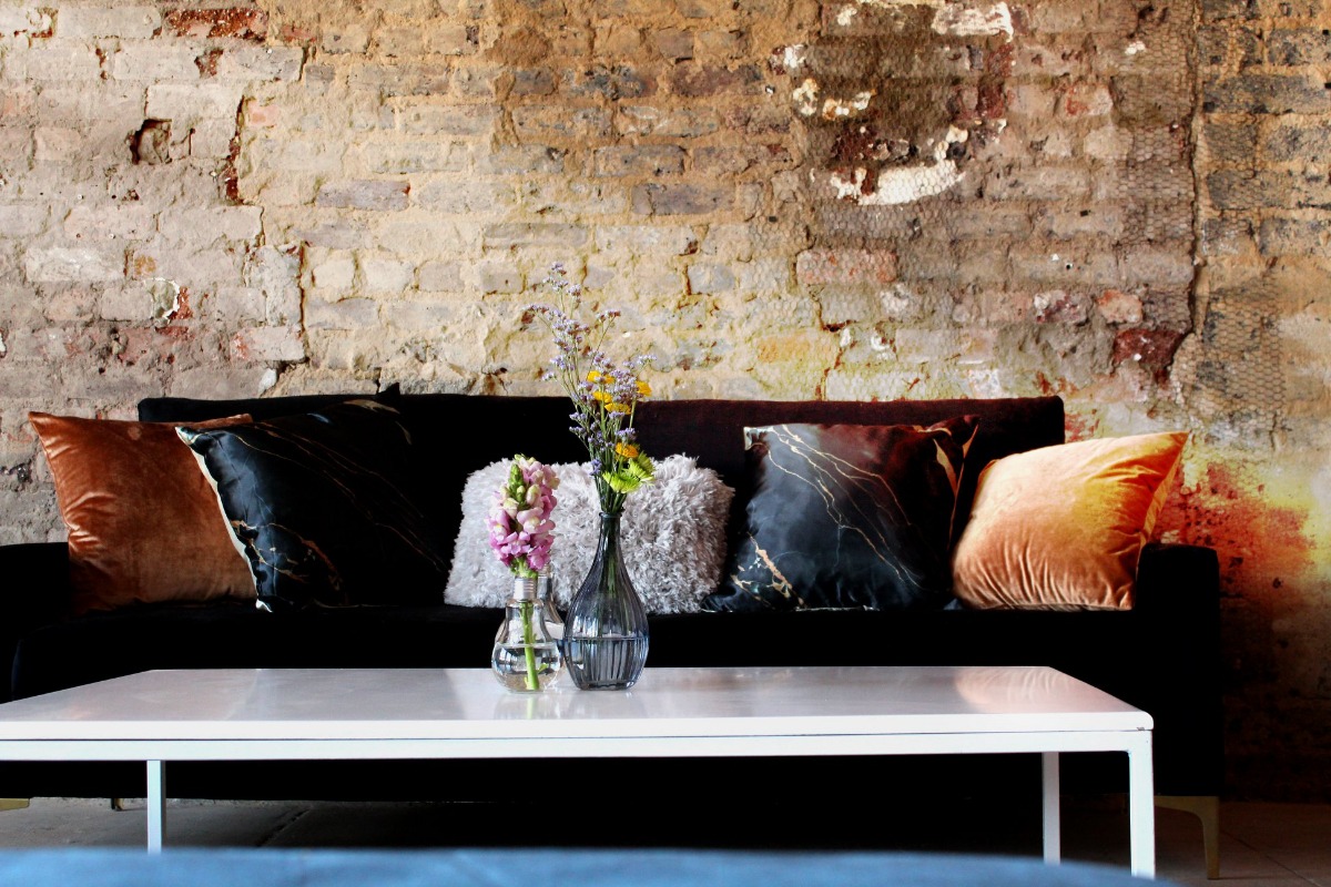 Modern event couch setup against exposed brick wall – Cape Town furniture rental