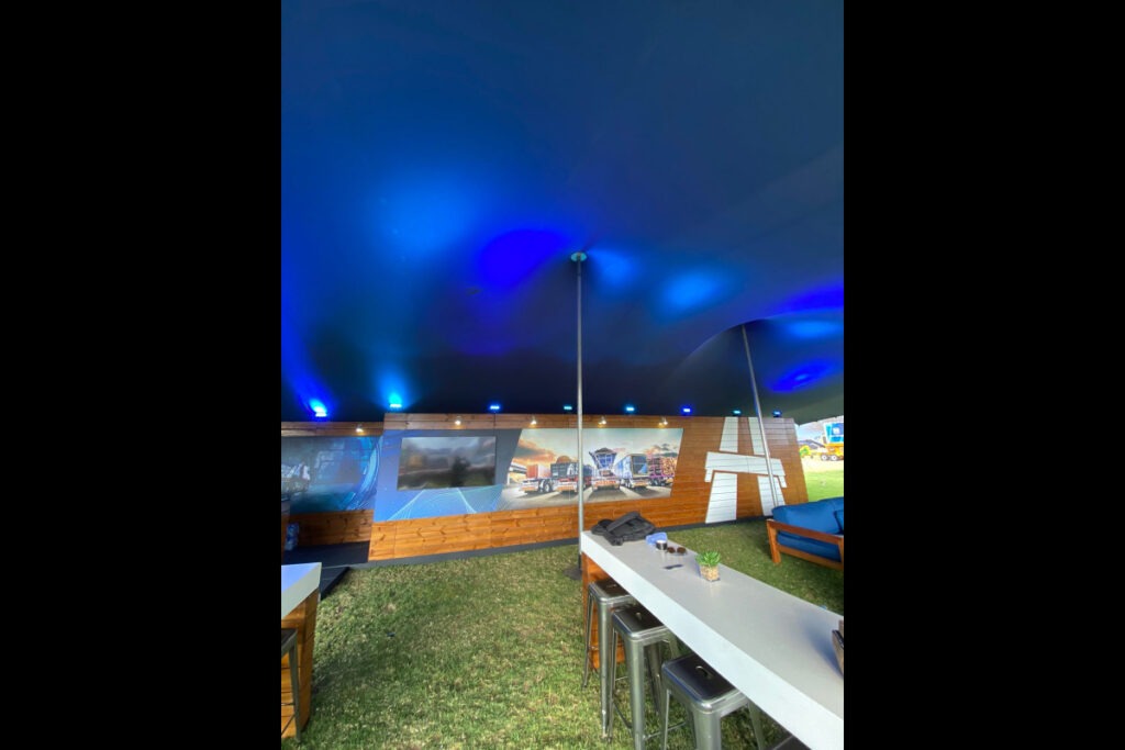 Expo tent with glowing blue LED lighting and staging