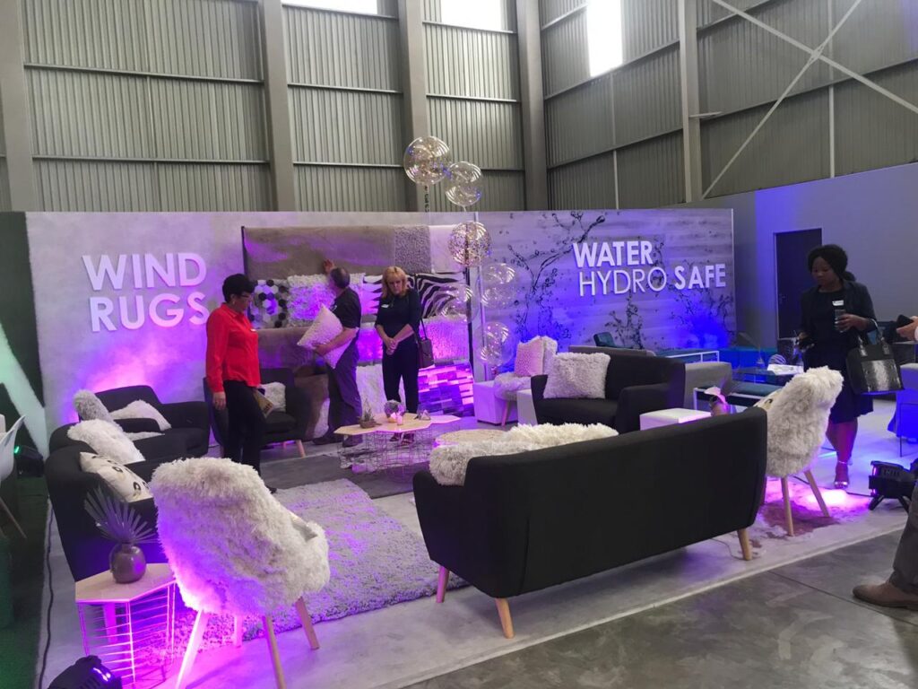 Expo booth with designer lounge furniture and LED lighting