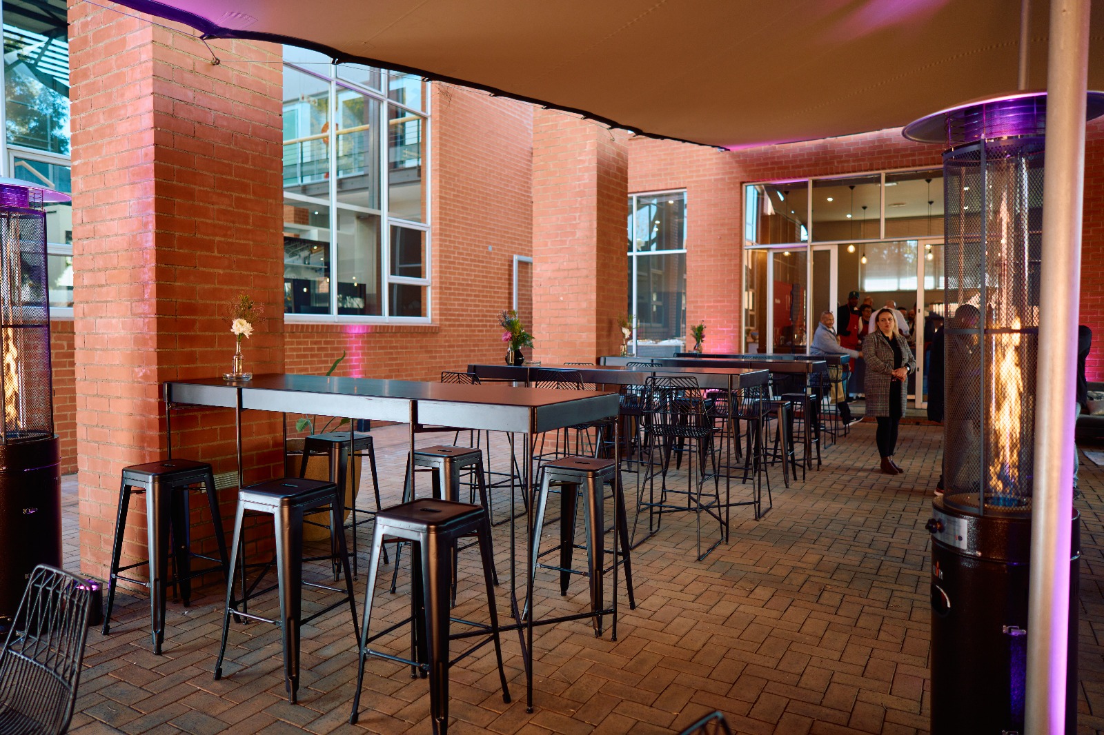Cocktail area with black high tables and stools for modern outdoor function