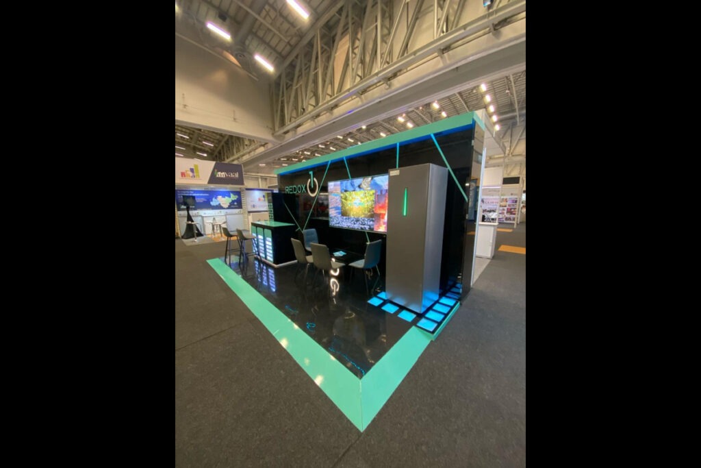 Custom exhibition stand with LED turquoise V-pattern base