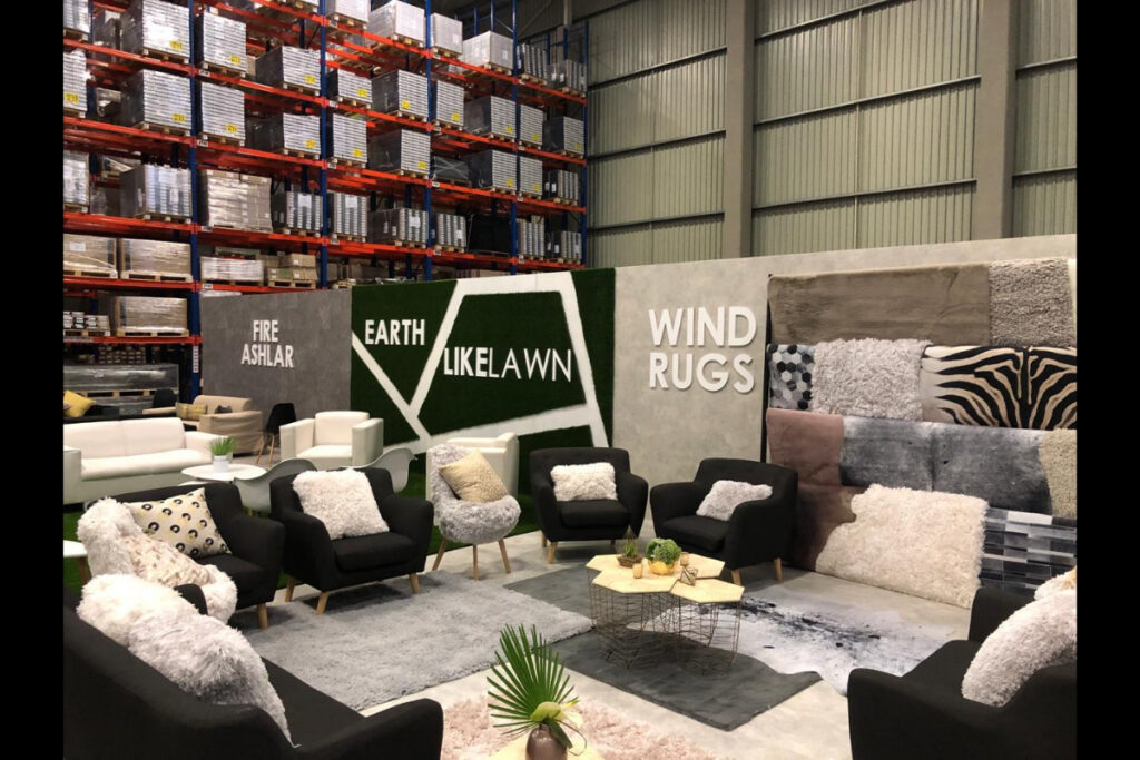 Custom lounge setup with branded turf wall at expo in Cape Town
