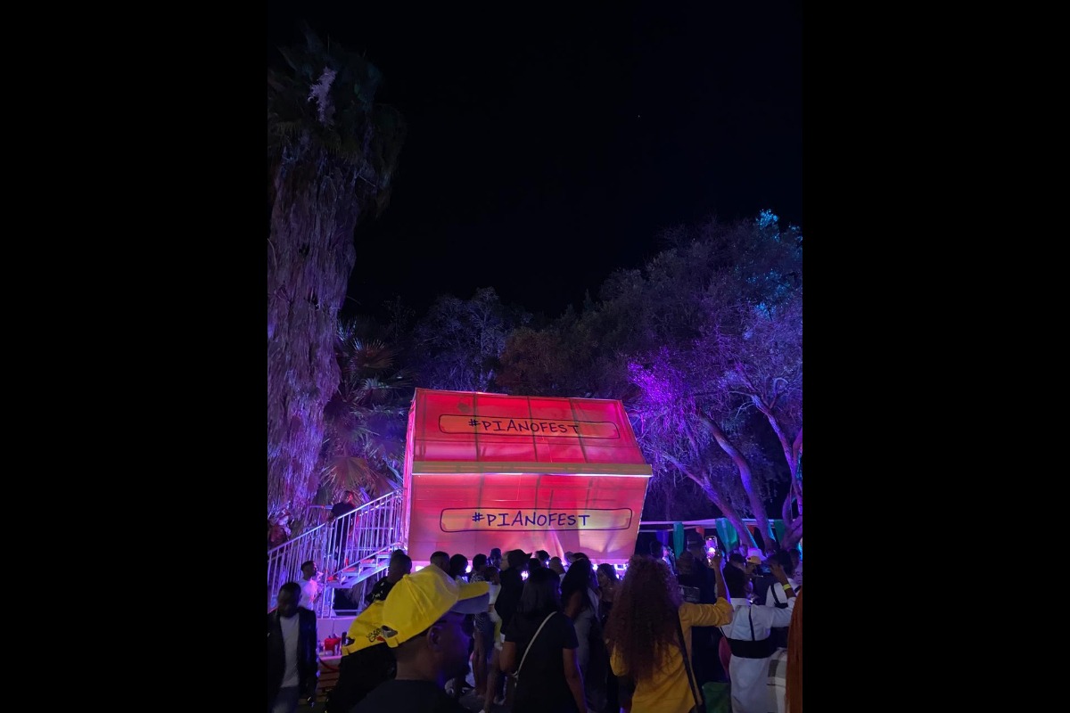 Outdoor stage and trees lit up with red lighting