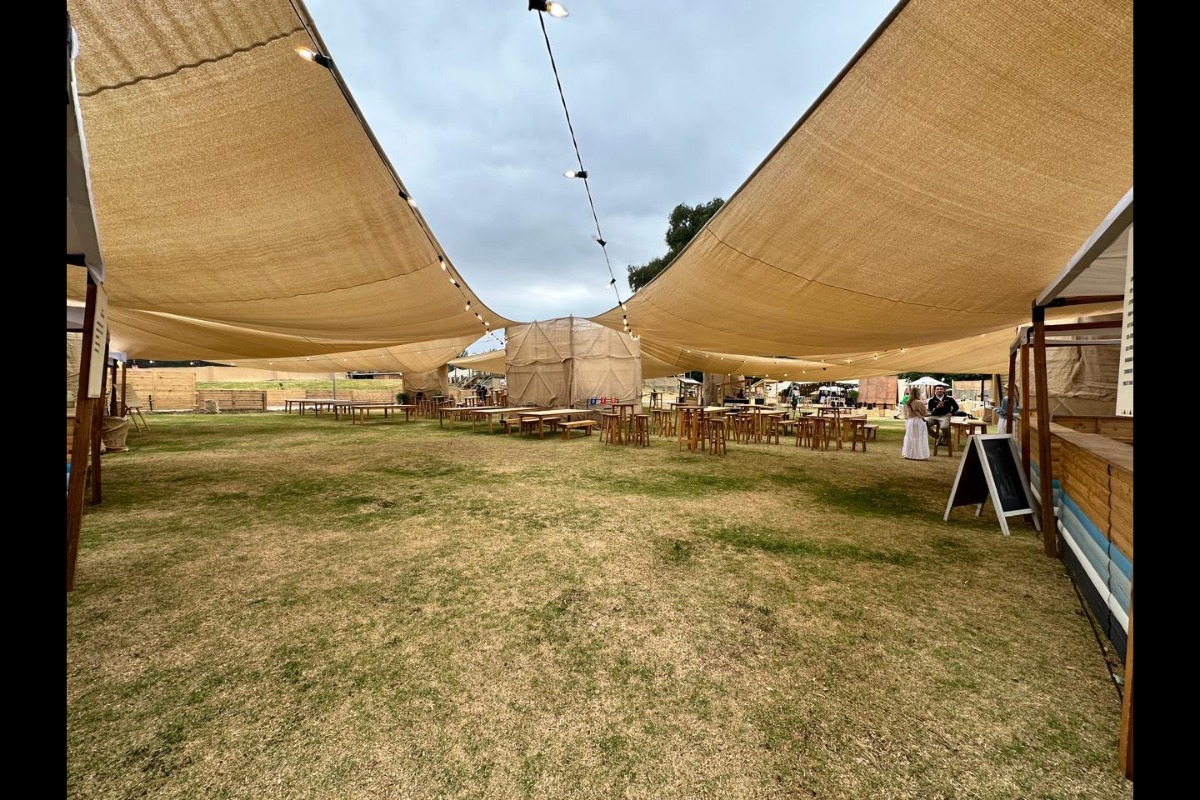 Stretch tent with overhead shade net draping setup for outdoor event in Cape Town