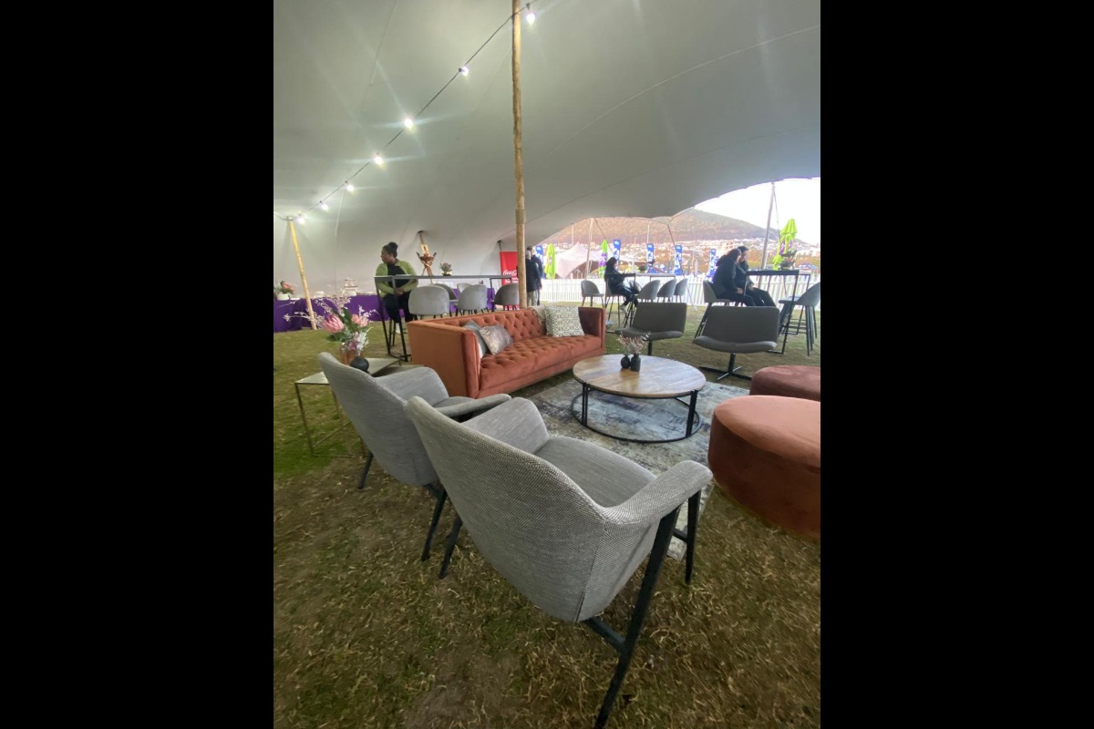 Grey and white event lounge seating under stretch tent by Animate-Co