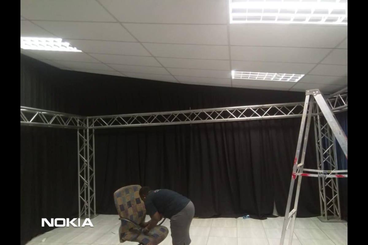 Black fabric draping installation on trussing for indoor event in South Africa