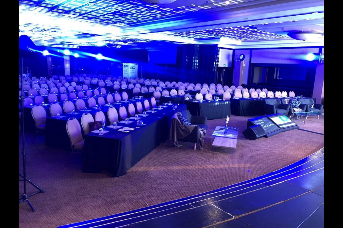Conference venue with draped ceiling and corporate seating setup
