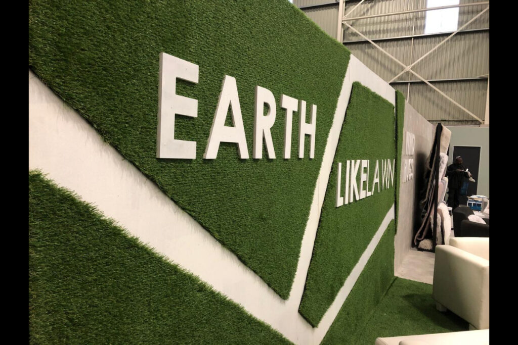 EarthLikeLawn branded artificial grass wall at trade show stand