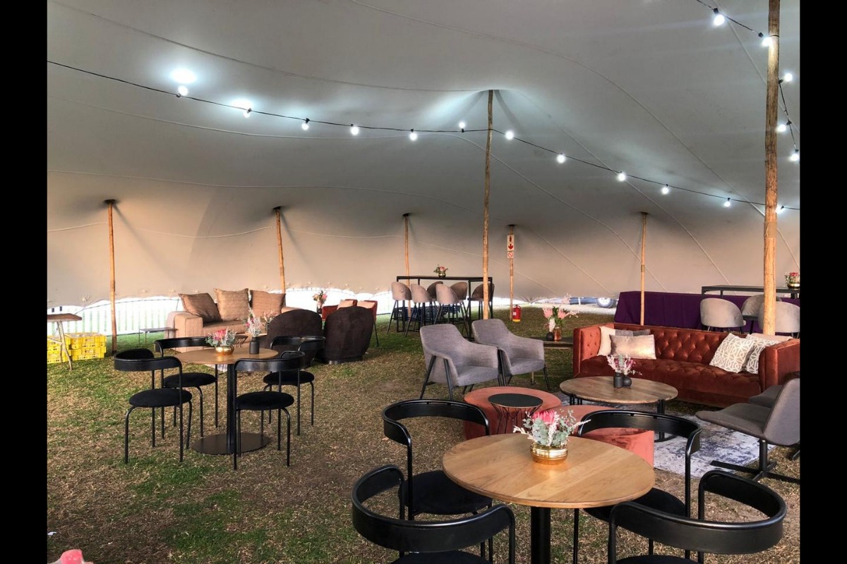 Fully styled stretch tent with lounge furniture for outdoor event – Animate-Co