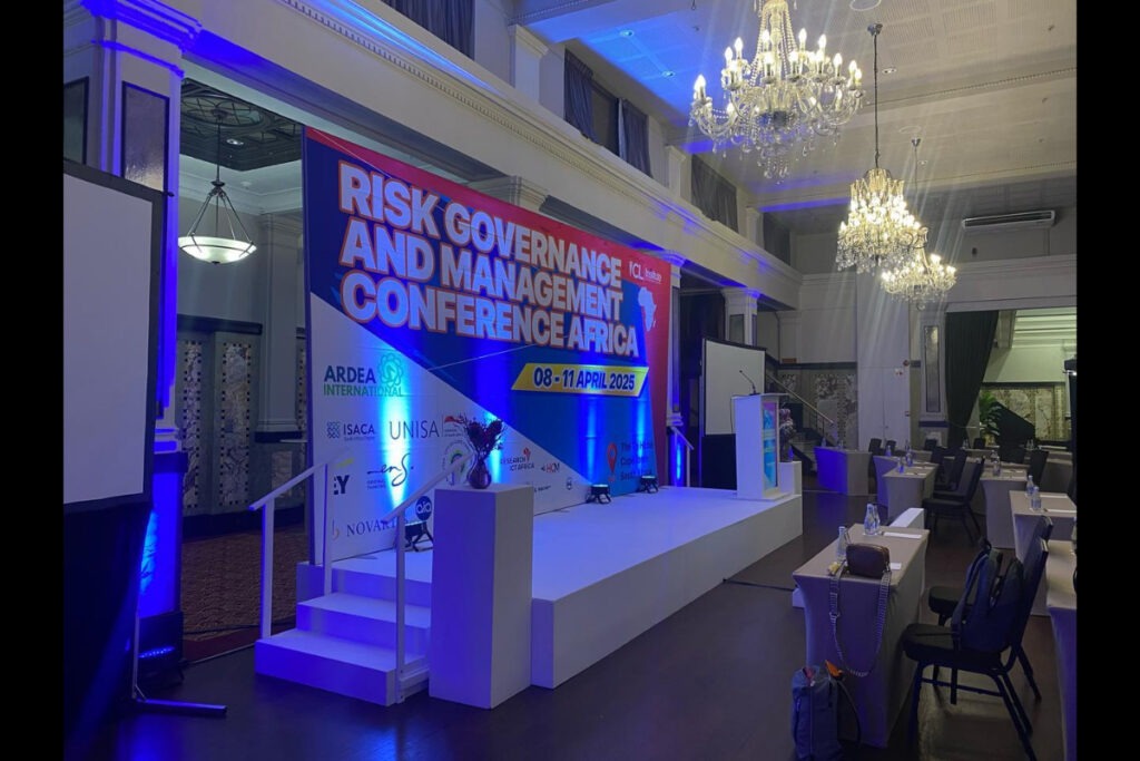Conference setup with stage lighting and Risk Governance branding – Cape Town