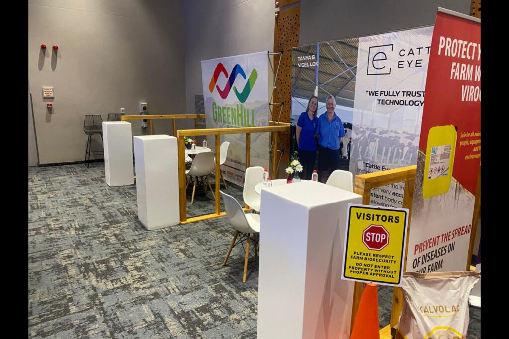 Eco Expo booth with branded panels and meeting furniture setup