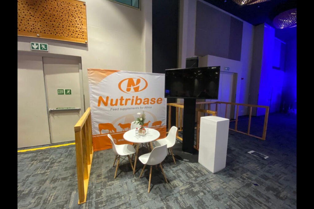 Nutribase branded expo stand with table and counter setup