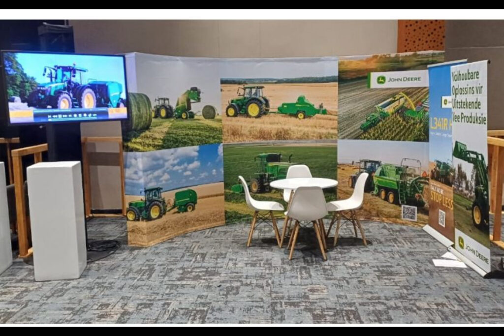 Agricultural-themed expo stand with curved backdrop and seating